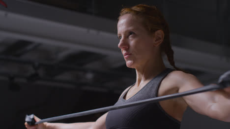 Studio-Shot-Of-Mature-Woman-Wearing-Gym-Fitness-Clothing-Exercising-With-Resistance-Band-2